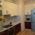Черно-бежевый радиусный кухонный гарнитур с глянцевыми дверями