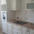 Белый классический угловой кухонный гарнитур с радиусными фасадами