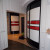 Встроенный угловой радиусный шкаф в коридор с яркими фасадами