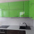Коричнево-зеленый угловой кухонный гарнитур с радиусными фасадами