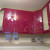 Красная угловая кухня с радиусными фасадами и цветочным декором