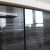 Чёрный прямой кухонный гарнитур с белыми навесными шкафами